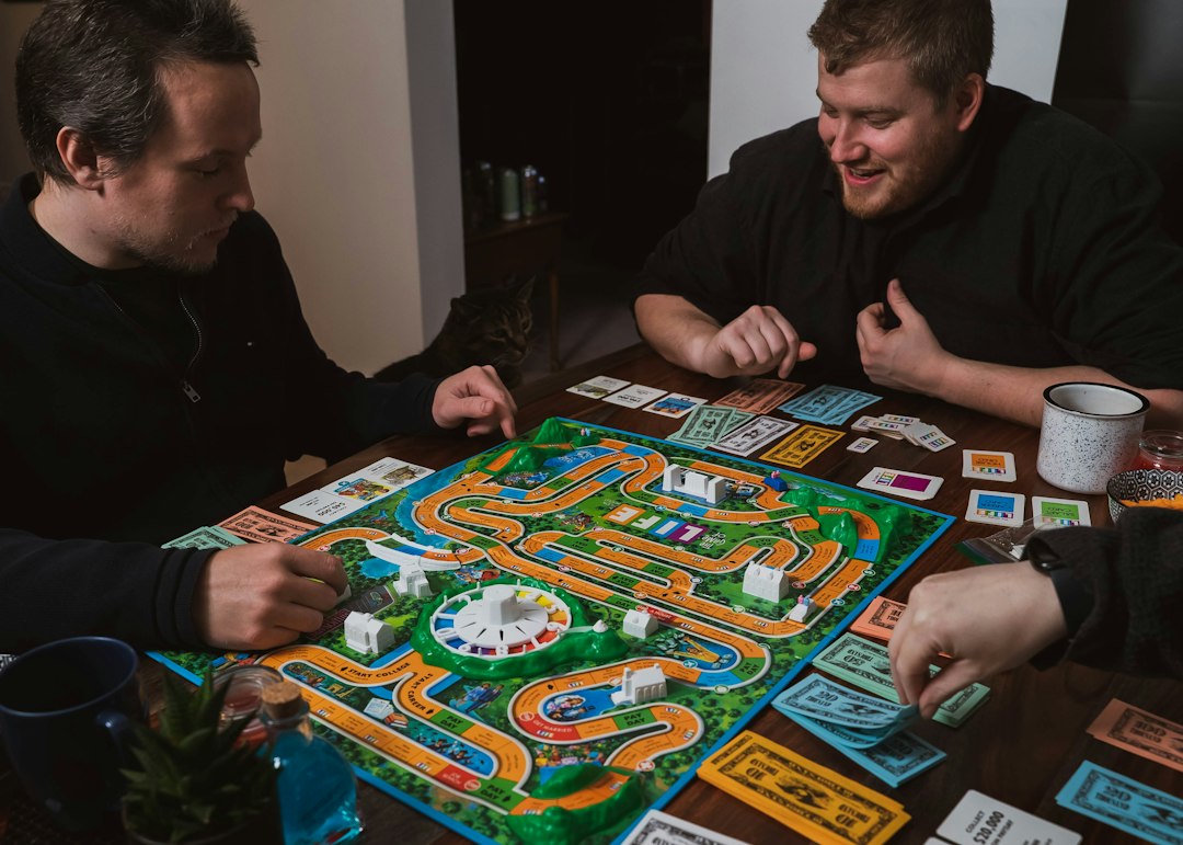Friends gathered around a board game in a relaxed social setting