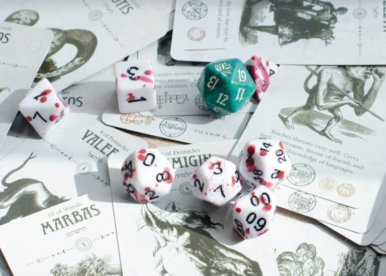 Dice sitting on cards used for tabletop roleplaying game activities