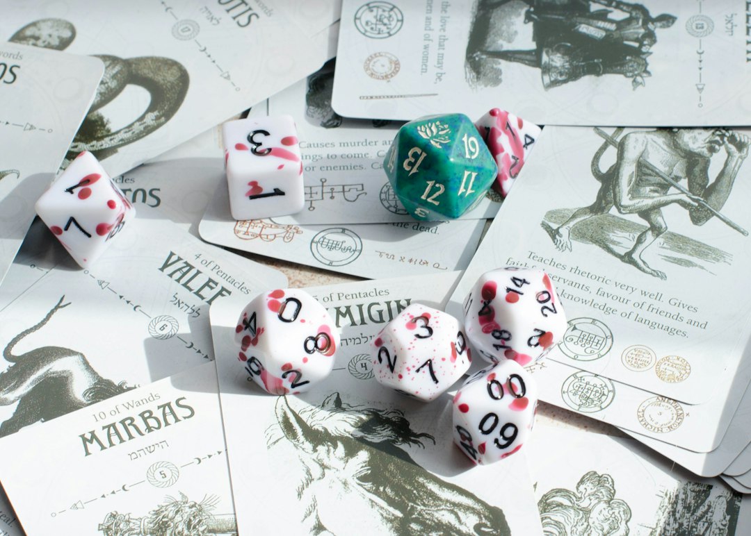 Dice sitting on cards used for tabletop roleplaying game activities