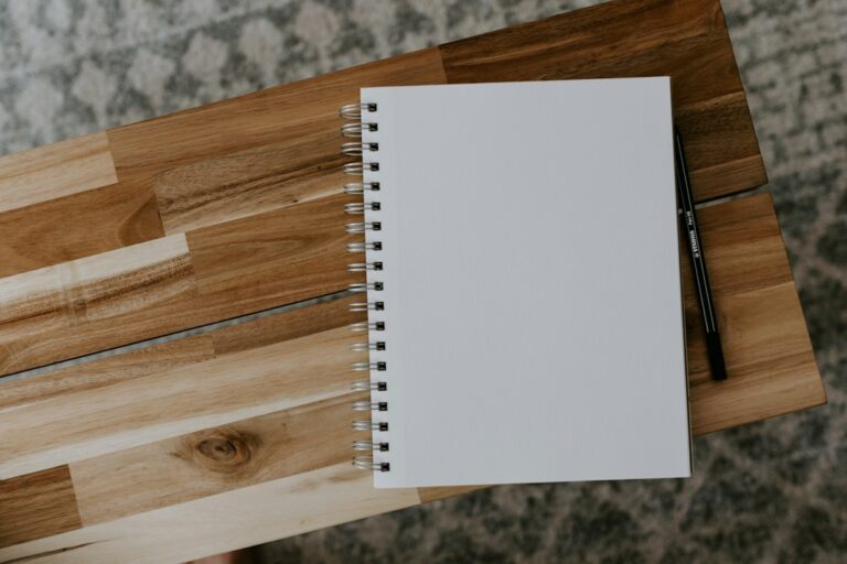 Spiral notebook on a wooden table for campaign tracking
